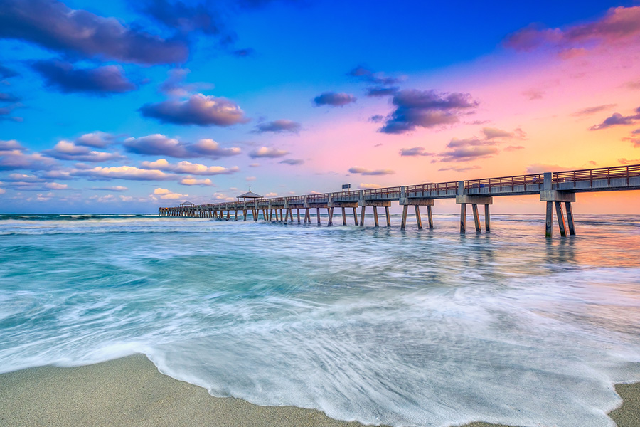 Ocean pier and beach at sunset in North Palm Beach